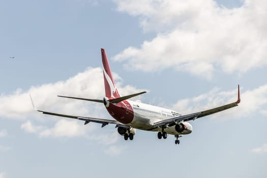 MELBOURNE, AUSTRALIA - SEPTEMBER 07, 2024: A Qantas Boeing 737-838 flies into Melbourne on September 7th 2024