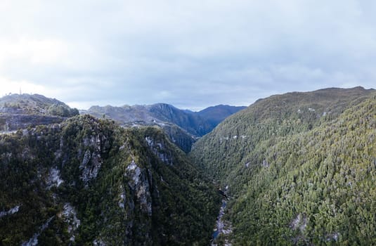 An aerial view of the Gordon Dam on a cool summer's day. It is a unique double curvature concrete arch dam with a spillway across the Gordon River near Strathgordon, South West Tasmania, Australia