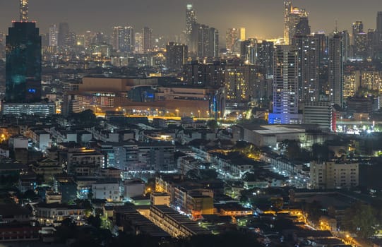 Bangkok, Thailand - 31 Dec, 2024 - Nightscape view after sunset of Skyscrapers in the business district of downtown in the Bangkok city. City night view of Modern buildings after sunset with bright glowing lights, use it as your Wallpaper, Poster and Copy space, Selective focus.