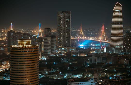 Bangkok, Thailand 31 Dec, 2024 - Night view after sunset of Skyscrapers in the business district and Bhumibol Bridge. Beautiful city of Bangkok with bright glowing lights in the sundown, use it as your Wallpaper, Poster and Copy space, Selective focus.