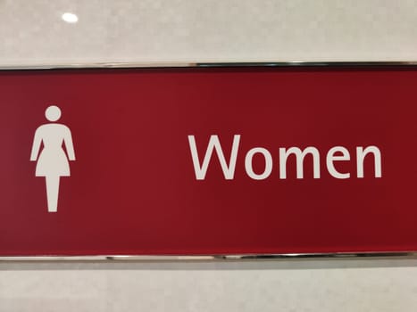 Restroom sign indicating the women s facilities in a contemporary setting with a bold design.