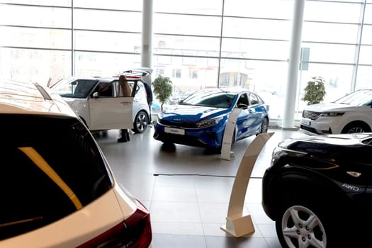Kazan, Russia - November 25, 2022: Cars in showroom of dealership Kia in Kazan in Russia. Partial focus