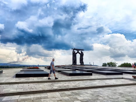 Magnitogorsk, Russia - July 18, 2024: Visitors explore the Magnitogorsk WWII memorial, showcasing a striking sculpture of a worker and soldier.