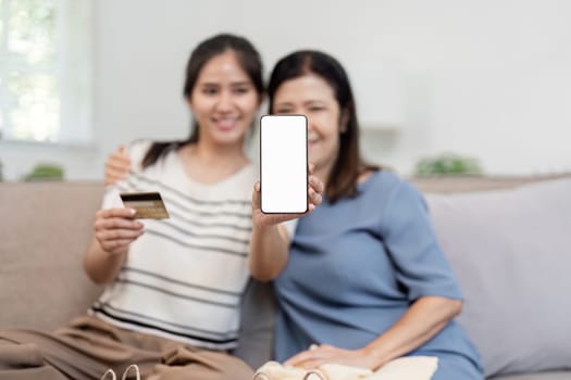 A mother and child using a smartphone for online shopping, highlighting modern family life and digital commerce.