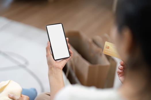 A mother and child using a smartphone app for online shopping, highlighting the convenience of digital purchases.