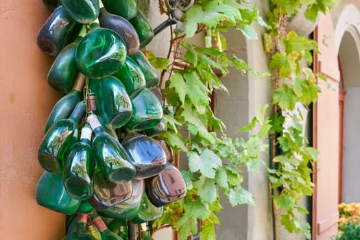 Wine bottles, so-called traditional Bocksbeutel, as decoration on a facade in Rothenburg ob der Tauber in Franconia in Germany
