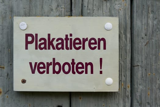 Sign with the German inscription Plakatieren verboten. Translation: Placarding prohibited