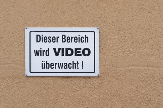 Sign with the german inscription dieser Bereich wird Videoüberwacht, this area is under video surveillance