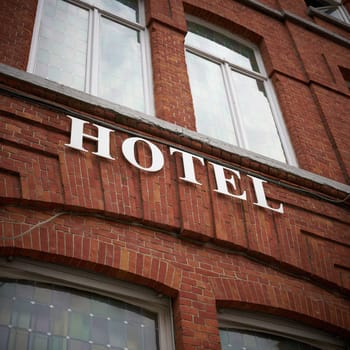 Hotel lettering on a brick facade in Bruges, Belgium