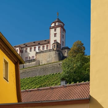 View of the Marienberg fortress in Wuerzburg, Germany through a gap between two buildings