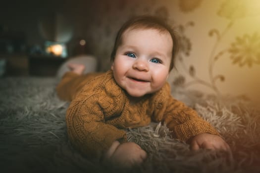 Adorable cute baby girl lying on bed and smiling. Adorable kid portrait. 5 month old child. Childhood concept. High quality photo