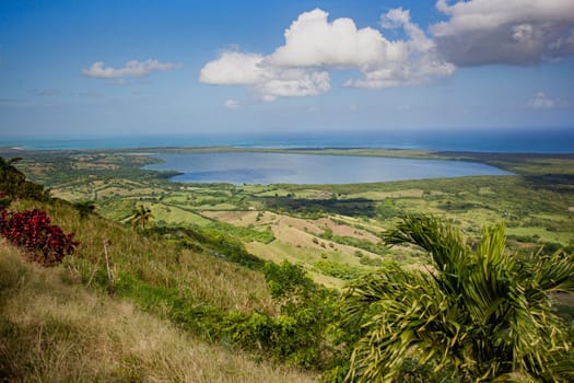 Scenic view of rolling hills, lush vegetation, and the tranquil caribbean sea from montana redonda in miches, dominican republic