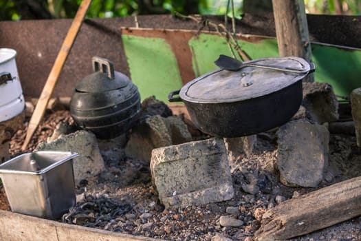 Traditional cooking scene in montana redonda, dominican republic, showcasing old pots and a makeshift stove