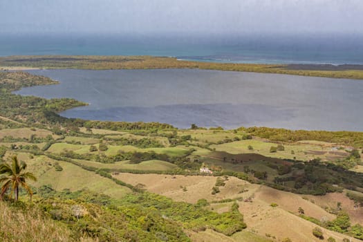 Scenic vista overlooking a tranquil lagoon and verdant hills in montana redonda, dominican republic, showcasing the beauty of caribbean nature