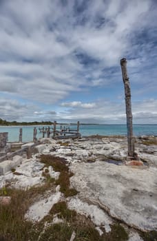 Old wooden pier falling into the turquoise waters of xpu-ha, in riviera maya, mexico