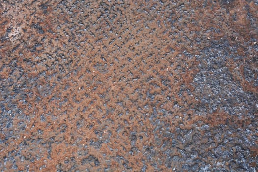 Close-up view of a corroded metal surface, revealing a rough texture with rust and decay