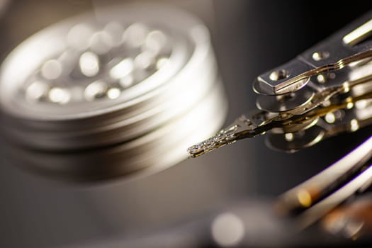 Close-up of a hard disk drive reading data from the platter, showcasing the intricate mechanics of data storage