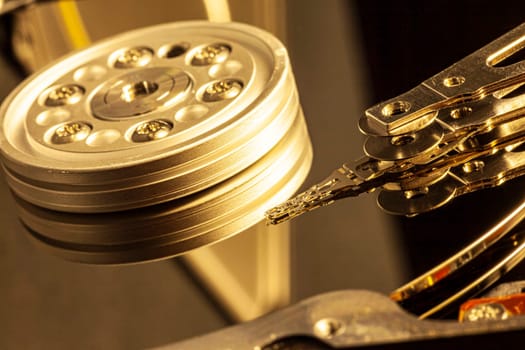 Close-up of an open hard disk drive reading data, with actuator arm and platters
