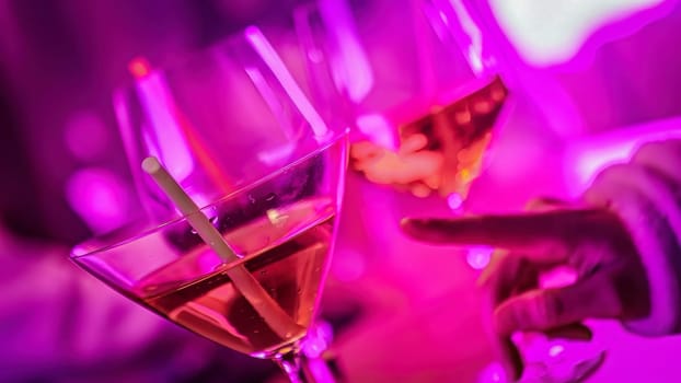Friends enjoying pink cocktails in a vibrant nightclub, celebrating with a toast under neon lights