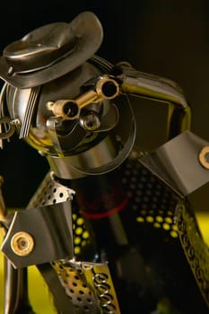Wine bottle holder made of recycled metal parts shaped like an explorer looking through binoculars