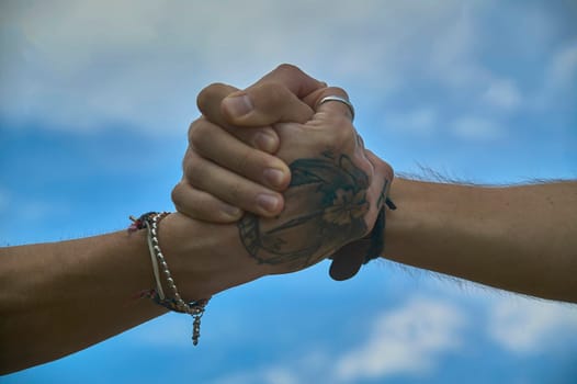 Two friends holding hands tightly, symbolizing their strong bond and support for each other