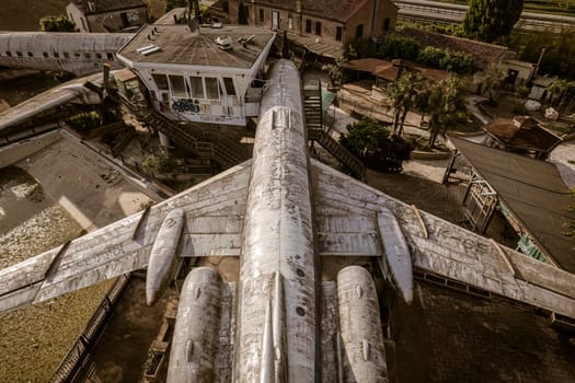 Aerial view of a repurposed tupolev tu-134 airplane, now serving as a distinctive entertainment space in italy