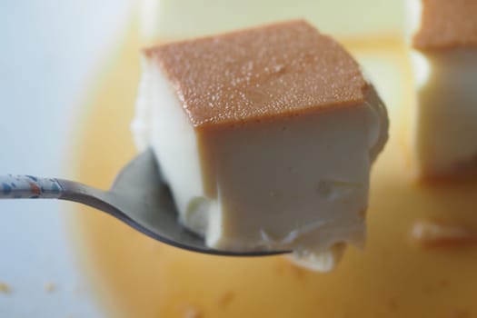 Caramel custard pudding on a plate on table ,