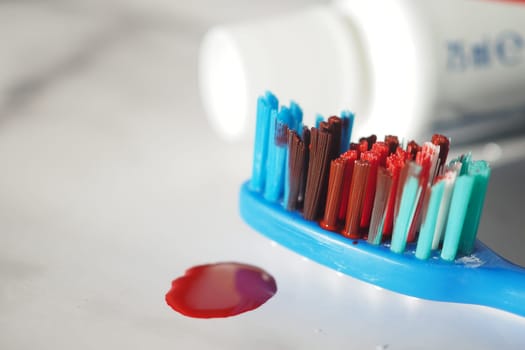 Blood on the toothbrush on background