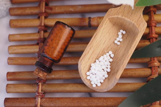 Homeopathic pills containers on a table .