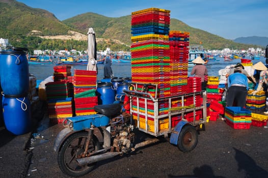 Vietnamese people at the fish market load empty boxes after selling fresh fish Vietnam. Nha Trang