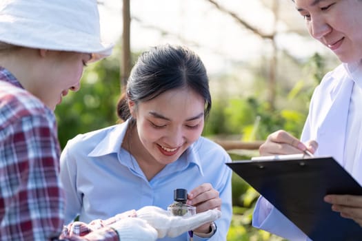 Researchers analyze cannabis samples in a greenhouse showcasing teamwork and dedication to plant science.