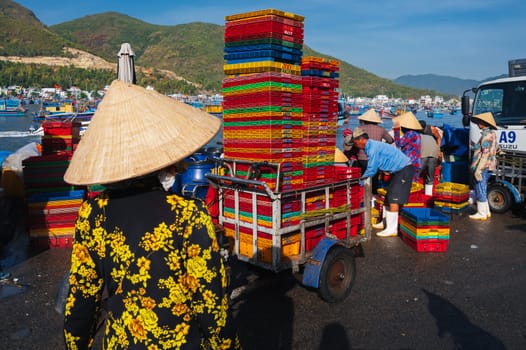 Unknown Vietnamese at a fish market in a fishing harbor. Vietnam, Nha Trang - September 8, 2024