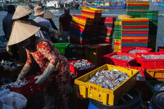 Vietnamese sellers unload and sell fresh sea fish at the fish market. Vietnam, Nha Trang - September 8, 2024