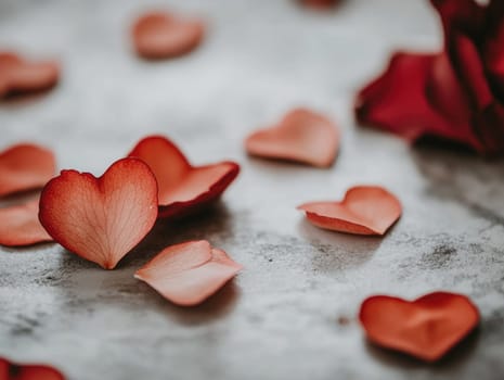Heart shaped petals on light grey surface for romantic designs and Valentines day themes.