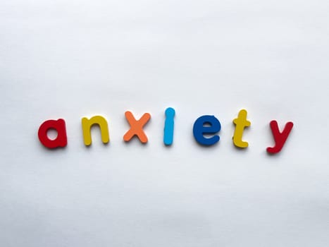Colorful letters spelling anxiety on white background.
