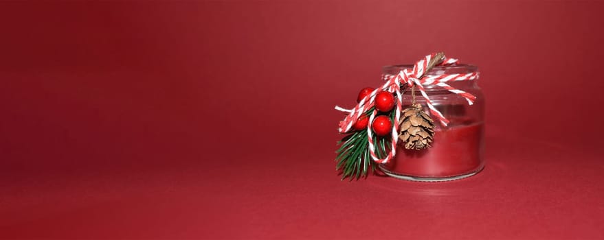 Banner with red decorative candle for christmas new year on a red background with space for text
