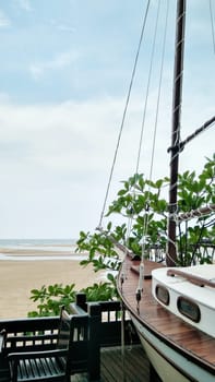 Seascape with decorative boat, greens and sand over tropical sea