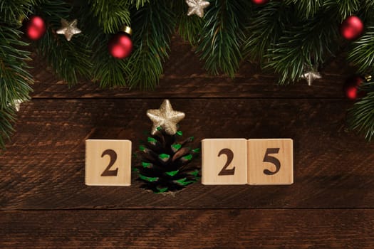 Figures 2025 New Year wooden blocks with fir branches, red Christmas tree balls and gold stars