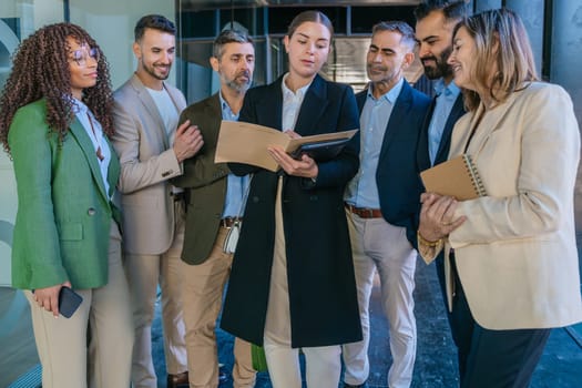 A diverse business team having a meeting and discussing ideas in a modern office. Professionals in formal attire collaborating with a notebook and tablet. Perfect for teamwork, business, and planning themes.