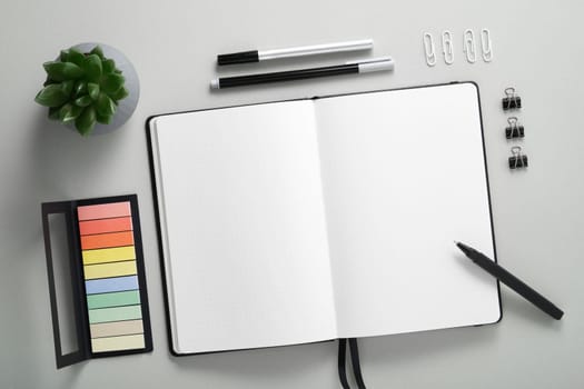 Blank notebook page for your text with black pen and pencil on gray background.
