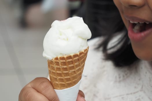 Child Hand Holding Vanilla Ice Cream in A Waffle Cone