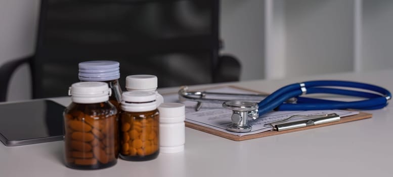 Medicine and stethoscope placed on the doctor's desk health care medicine..