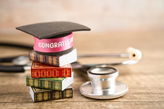 Stethoscope with graduation hat on book with copy space, learning university education concept.