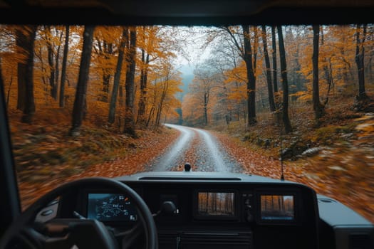 An unmanned vehicle equipped with artificial intelligence is driving along an autumn road. View from the car interior to the road.