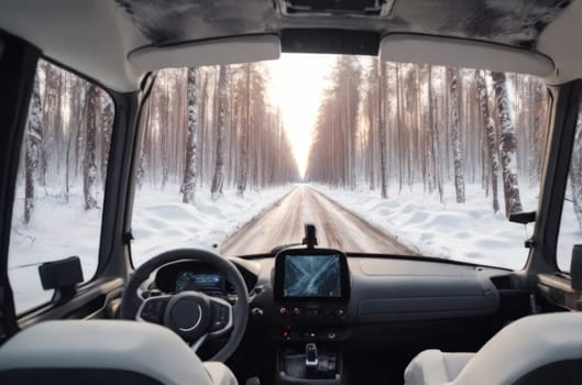 An unmanned vehicle equipped with artificial intelligence is driving on a winter road. View from the car interior to the road.