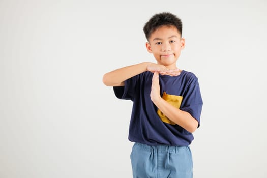 Closeup portrait young kid boy smiling making give time out gesture with hands studio shot isolated on white background, primary child demonstrates break hand sign, stop time with copy space