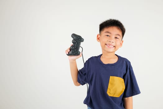 Asian happy portrait young kid boy smile lifestyle games technology holding joystick game playing on hands studio shot isolated on white background with copy space, primary children relaxation time