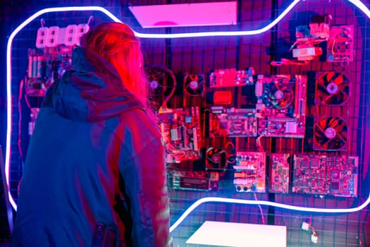 Asian woman wearing a black jacket hacking programming system check hacking hardware circuit in dark office, Cyber security agency developing, Computer electronics and technique