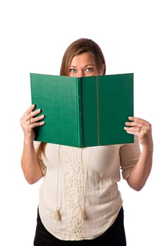 Woman holding a large green book to hide her face