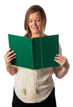 Forty something woman, wearing casual clothes, reading a large green book, isolated against a white background